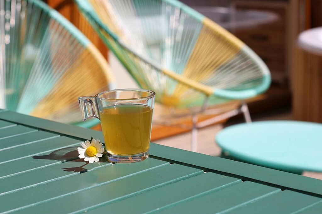 A plain mug of chamomile tea on a bedside table with soft evening light.