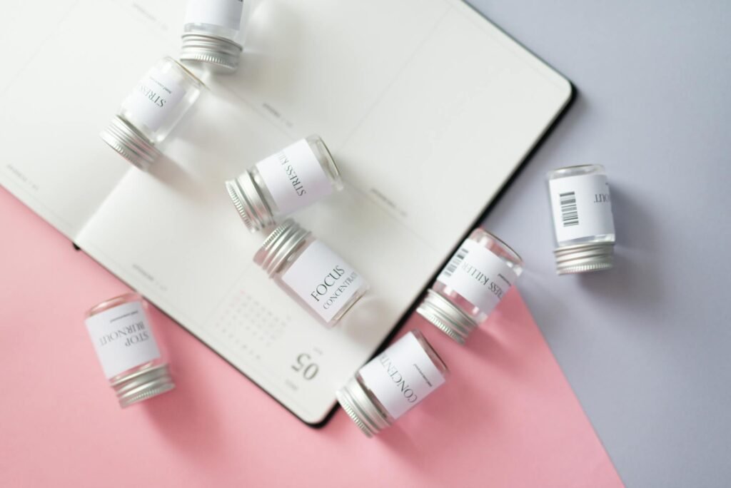 A home workspace with a mug, calendar, and a small herbal bottle