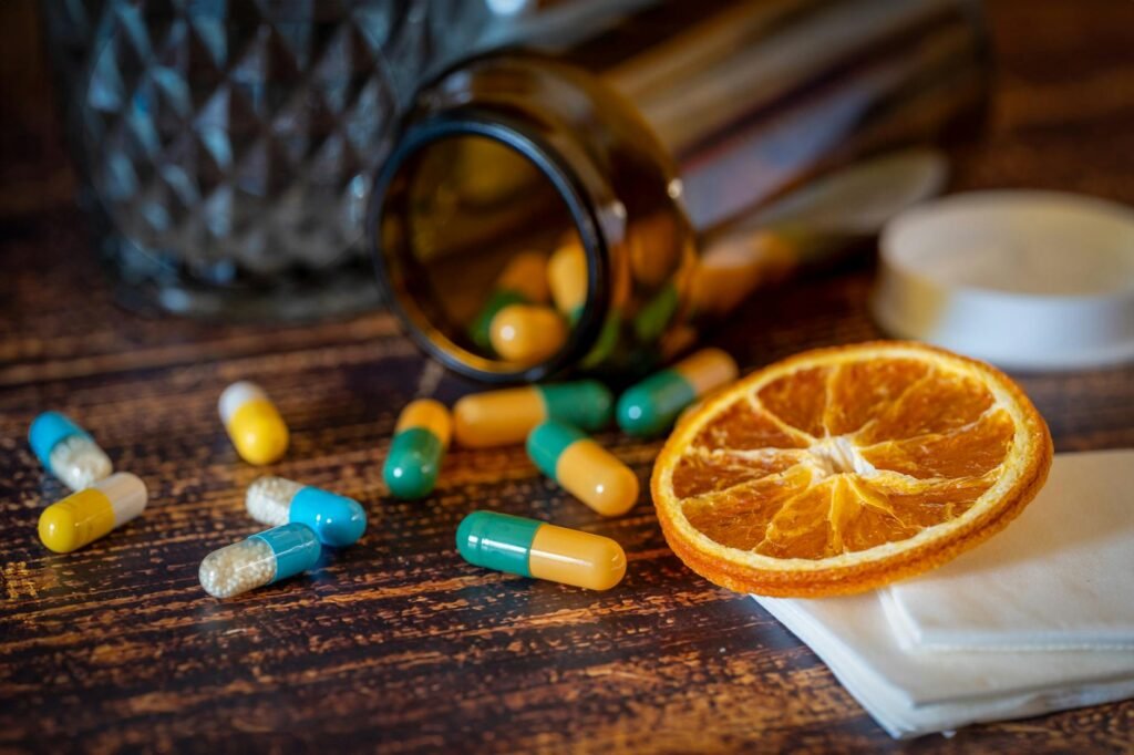 A close-up of a supplement bottle showing a Supplement Facts panel next to loose herbs.
