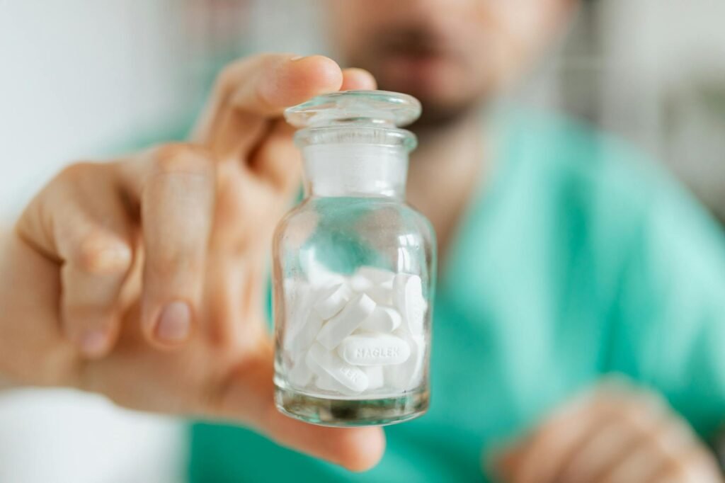 Person reading the ingredient panel on a supplement bottle