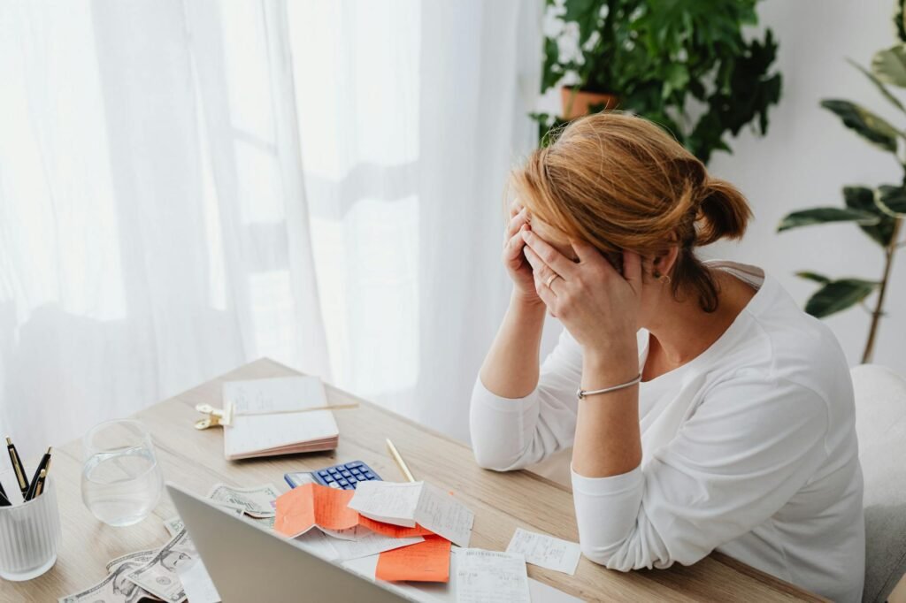 A calculator, receipts, and a small herbal tea purchase next to a handwritten budget list