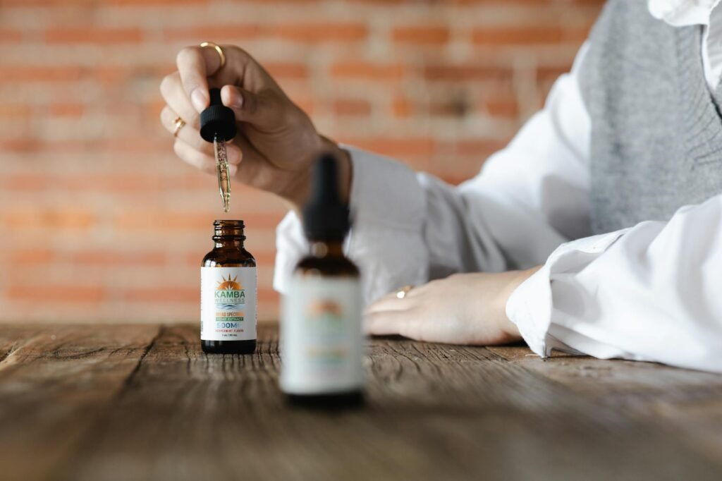 Hands holding a supplement bottle and reading the Supplement Facts panel