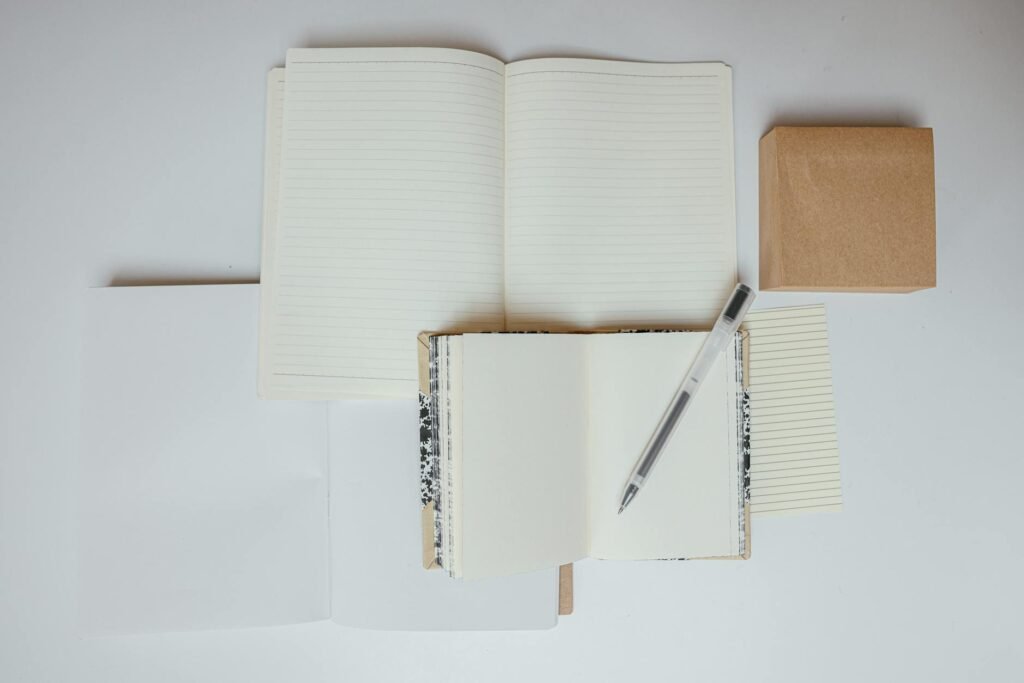 A close-up of an ingredient label beside a pen and notebook