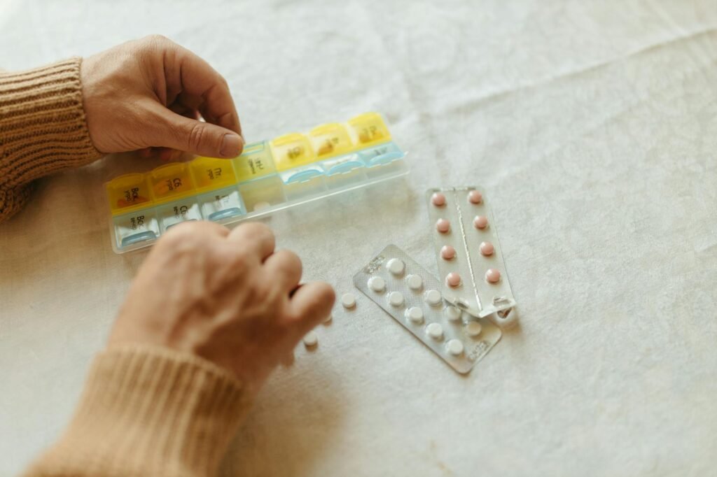 A close-up view of a Supplement Facts label beside a pill organizer.