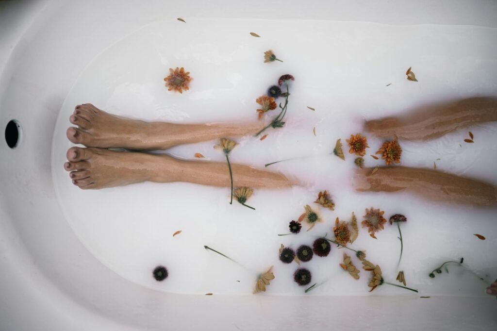 A towel, basin, muslin bag, and small bowl of dried herbs arranged neatly on a floor mat