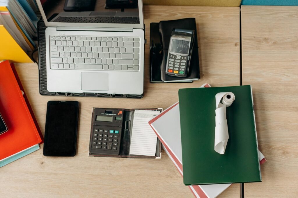 Supplement bottles, a receipt, and a calculator on an organized desk