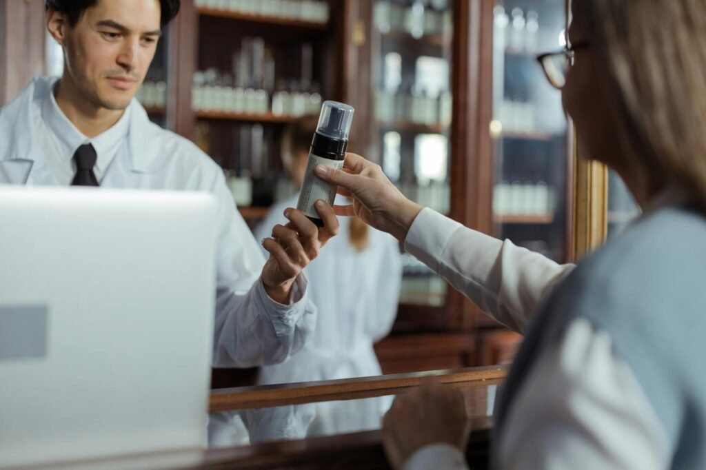 A pharmacist reviewing an herbal supplement bottle with a customer