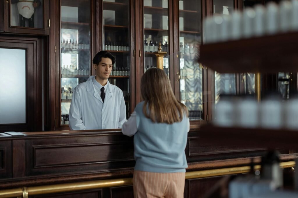A pharmacist reviewing a medication list next to a supplement bottle