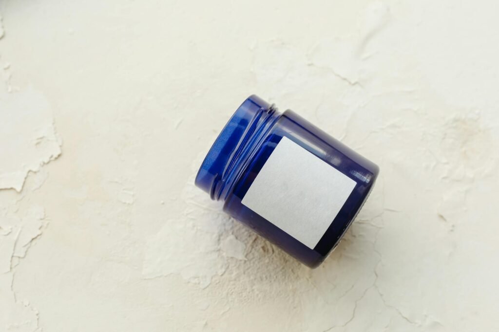 Close-up of a supplement bottle label beside reading glasses on a table