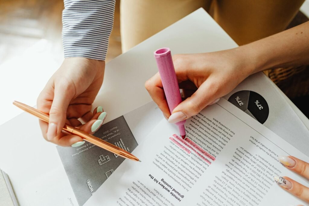 A desk with a supplement bottle, printed notes, and a pen for reviewing product claims.