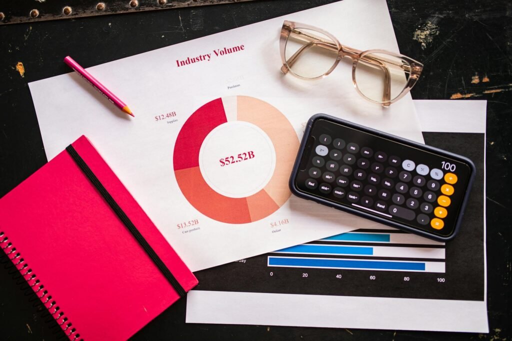 A person reading a supplement label next to a calculator and notebook