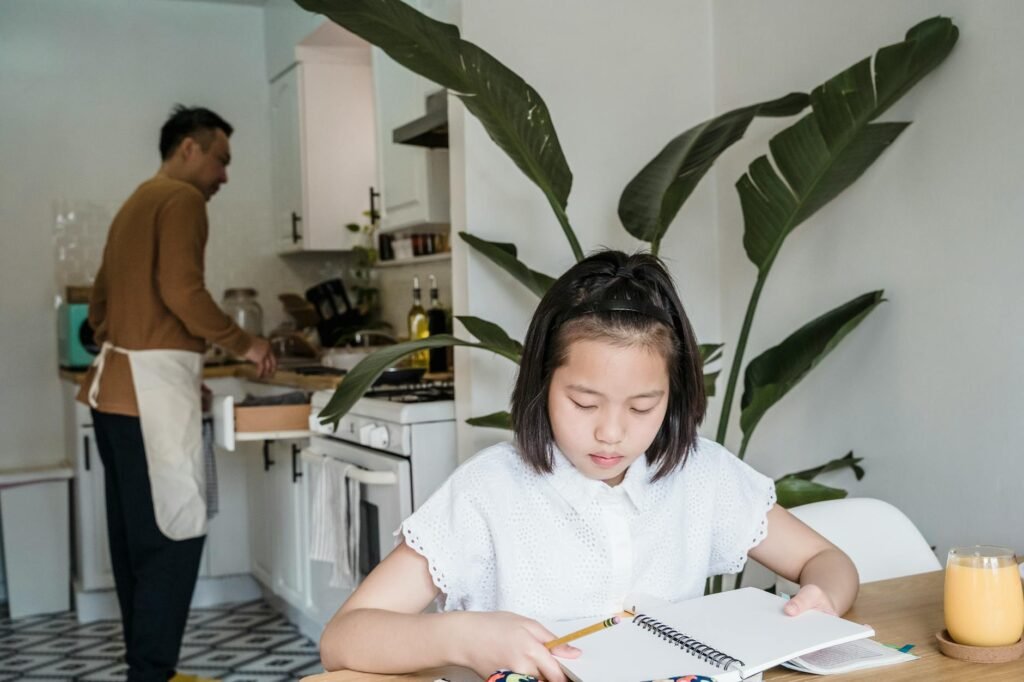 Parent comparing a supplement label with a child’s medication list at a kitchen table